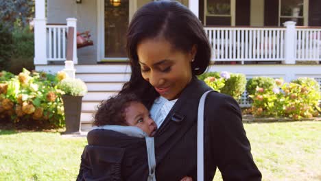 Portrait-Of-Businesswoman-With-Baby-Son-Leaving-House-For-Work