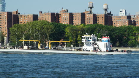 Cargo-Boat-On-Hudson-River-With-Manhattan-Skyline-In-Background