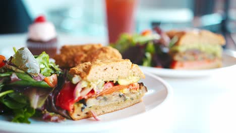 Pull-Focus-Shot-Of-Vegan-Sandwiches-On-Plate-In-Coffee-Shop