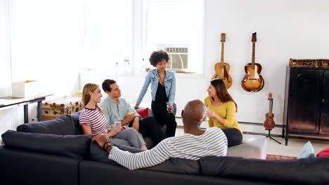 Five-adult-friends-socialising-at-a-New-York-loft-apartment