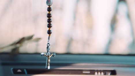 Close-Up-Of-Crucifix-Hanging-Inside-Car-In-New-York