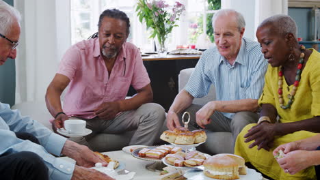 Group-Of-Senior-Friends-Enjoying-Afternoon-Tea-At-Home-Together