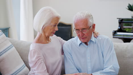 Senior-Woman-Comforting-Man-With-Depression-At-Home