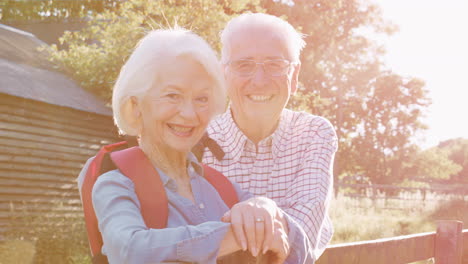 Portrait-Of-Senior-Couple-Hiking-In-Countryside-Together