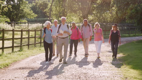 Group-Of-Senior-Friends-Hiking-In-Countryside-Together