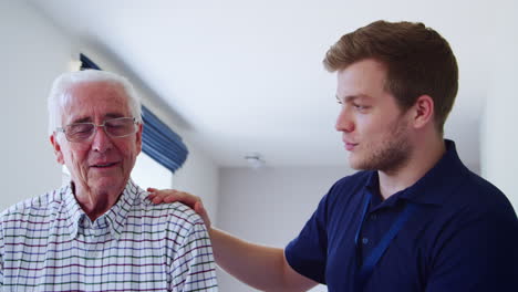 Male-nurse-talking-to-senior-man-at-home,-close-up