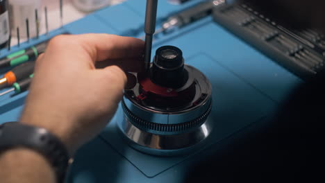 Male-Technician-Disassemble-Cine-Lens-for-Repair