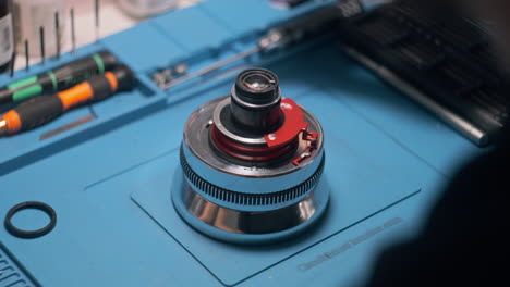 Male-Technician-Unscrews-Cine-Lens-for-Repair