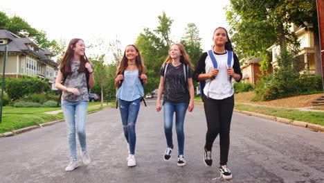 Four-teen-girls-walking-in-road,-full-length-tracking-shot