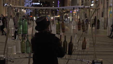 Man-playing-on-glass-bottles-to-earn-money