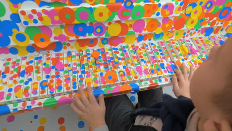 Boy-playing-the-piano-in-Obliteration-Room-by-Yayoi-Kusama