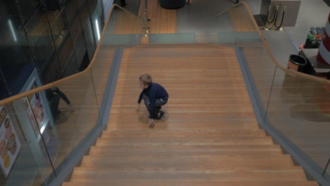 Child-having-fun-on-the-staircase-in-the-hall