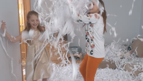 Two-friends-dancing-and-having-fun-with-paper-confetti