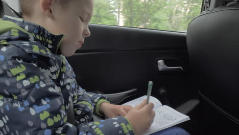 Child-solving-chess-puzzles-during-car-travel