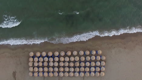Empty-sunbeds-at-the-seaside-aerial