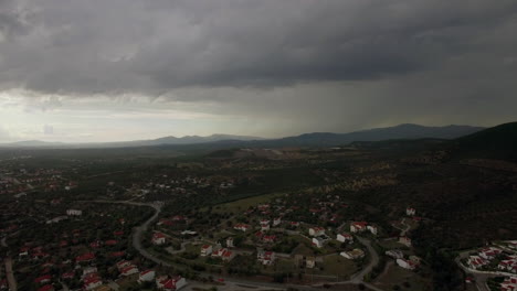 Drone-flying-and-descending-over-town-view-to-cottages-and-green-spaces-Greece