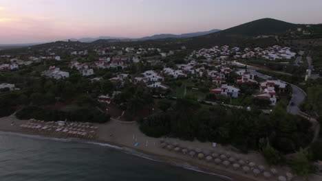 Aerial-shot-of-seaside-and-villas-of-Trikorfo-Beach-Greece