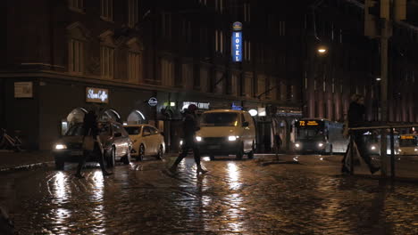 Paved-street-with-car-and-people-traffic-in-night-Helsinki-Finland