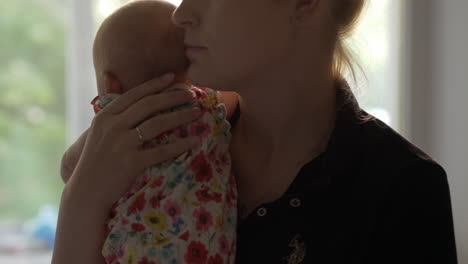 Loving-and-careful-mother-with-baby-daughter-at-home