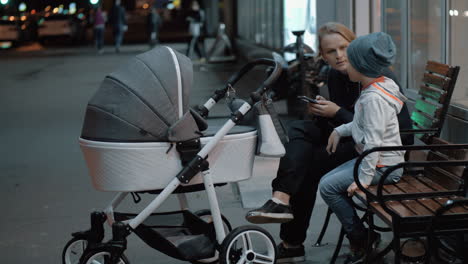 Woman-with-baby-and-elder-son-spending-evening-outside