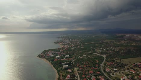 Flying-over-the-town-on-coast-View-with-overcast-sky-Greece