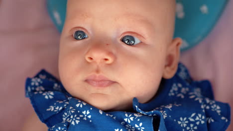 Portrait-of-baby-girl-in-blue-onesie