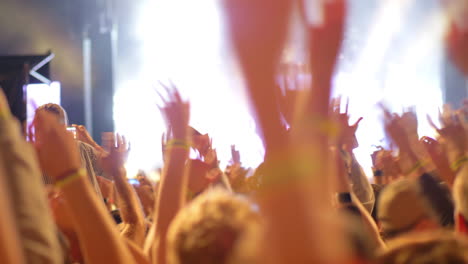 A-crowd-of-music-fans-waving-hands-on-an-open-air-concert