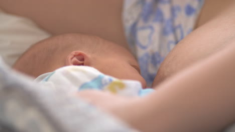 Tired-and-sleepy-mother-breastfeeding-newborn-baby