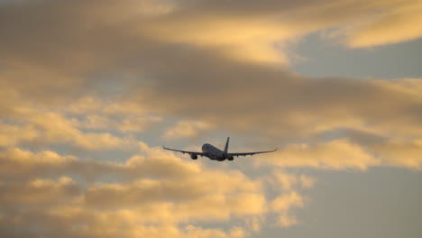 Plane-in-cloudy-evening-sky
