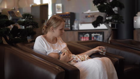 Mother-breastfeeding-baby-in-hotel-hall