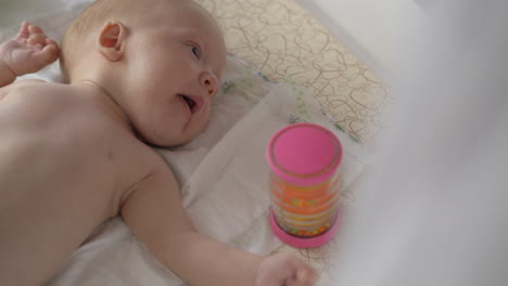 Two-months-baby-and-rattle-box-toy