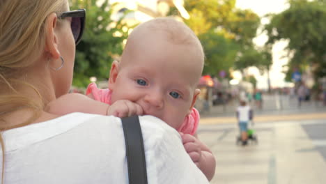Baby-having-outdoor-walk-in-mothers-arms
