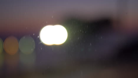 Window-view-to-the-lantern-and-cars-with-headlights-defocus