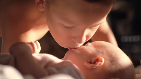 Boy-giving-kiss-to-baby-sister