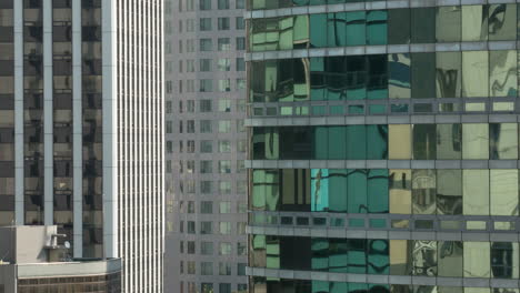 Timelapse-close-up-view-of-part-of-skyscrapers-mirror-rank-of-windows