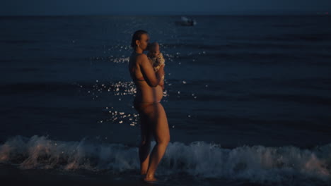 Mother-with-baby-enjoying-sea-breeze-at-night