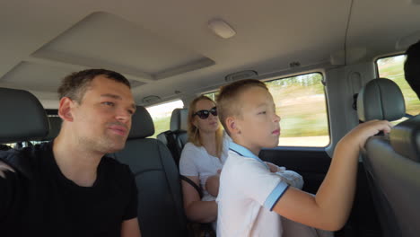 Parents-with-two-kids-having-car-journey