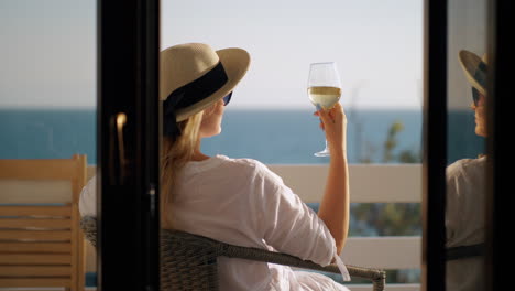 Frau-Entspannt-Sich-In-Einsamkeit,-Trinkt-Wein-Und-Genießt-Den-Blick-Aufs-Meer