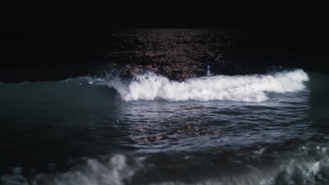 Night-waterscape-with-waving-sea-rolling-in-on-the-shore