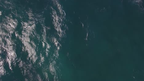 Flying-over-ocean-with-big-foamy-waves