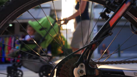 View-through-bike-wheel-to-street-and-sun-flare