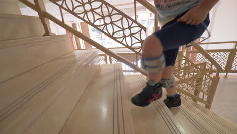 Kid-with-foot-drop-system-walking-upstairs