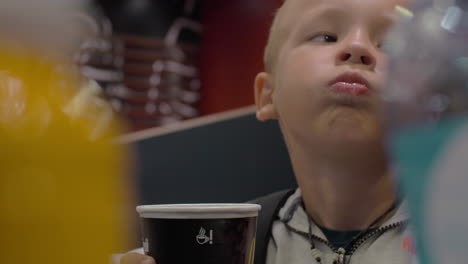 Boy-drinking-tea-in-McDonald-fast-food-restaurant