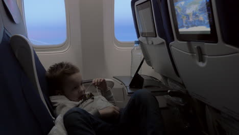 Child-watching-cartoon-on-smartphone-in-airplane