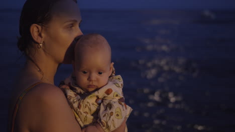 Mom-with-baby-on-the-beach-at-night
