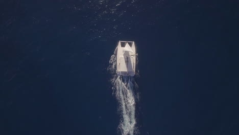 Flying-over-white-yacht-sailing-in-blue-ocean