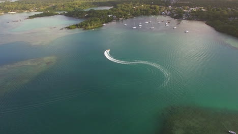 Flying-over-motor-boat-sailing-in-bay-Mauritius-Island