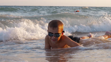Child-is-excited-with-sea-waves-covering-him