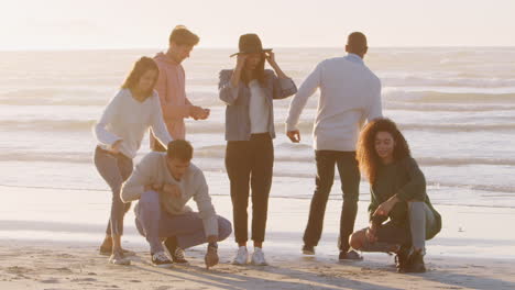 Group-Of-Friends-Having-Fun-On-Winter-Beach-Together