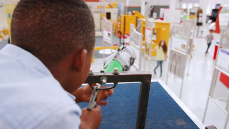 Young-black-boy-using-air-pressure-rocket-at-science-centre